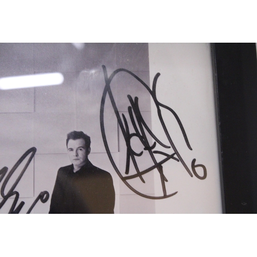 880 - A SIGNED FRAMED PHOTOGRAPH OF WESTLIFE - NO PROVENANCE