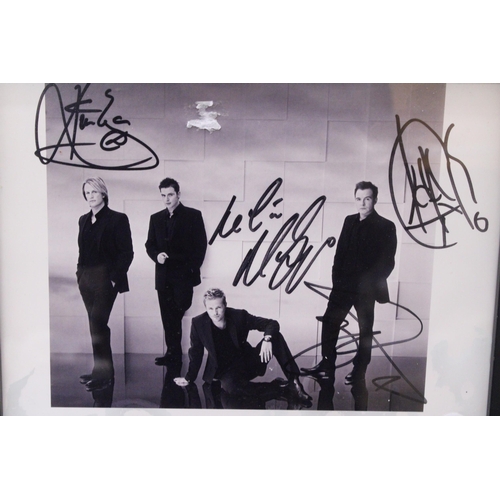 880 - A SIGNED FRAMED PHOTOGRAPH OF WESTLIFE - NO PROVENANCE