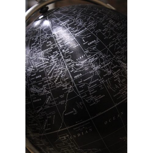 888 - A BLACK STANDING DESK GLOBE WITH A MAP OF THE WORLD