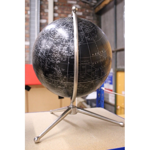 888 - A BLACK STANDING DESK GLOBE WITH A MAP OF THE WORLD