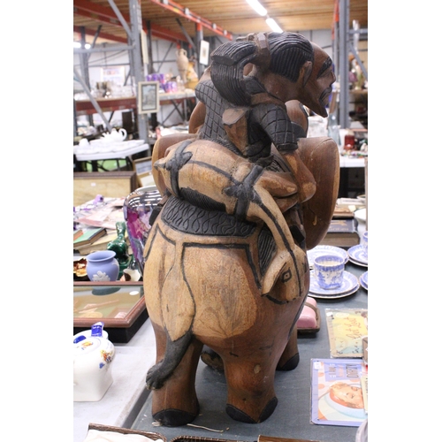 967 - A VERY HEAVY CARVED WOODEN ELEPHANT AND RIDER, HEIGHT 58CM, LENGTH APPROX 36CM