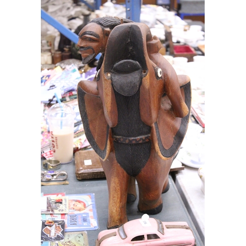 967 - A VERY HEAVY CARVED WOODEN ELEPHANT AND RIDER, HEIGHT 58CM, LENGTH APPROX 36CM