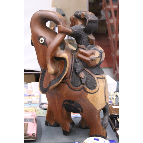 967 - A VERY HEAVY CARVED WOODEN ELEPHANT AND RIDER, HEIGHT 58CM, LENGTH APPROX 36CM