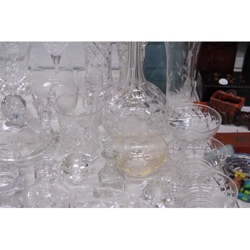 1023 - A LARGE COLLECTION OF GLASSWARE TO INCLUDE A DECAMTER, VASES, DESSERT BOWLS, CANDLE HOLDERS, GLASES,... 