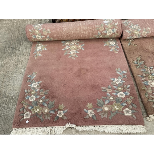 2488 - THREE VARIOUS PINK PATTERNED FRINGED RUGS