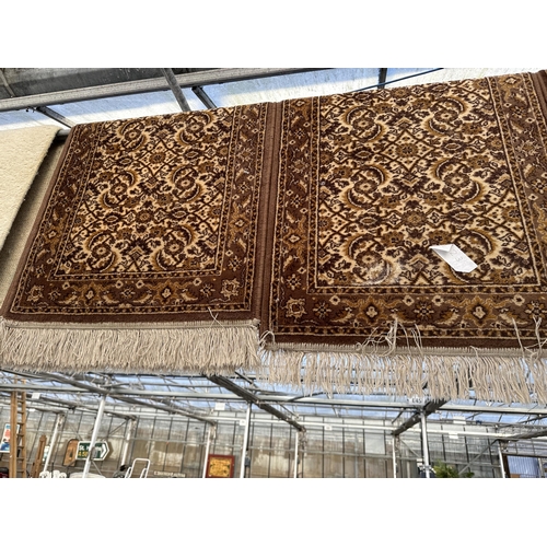 2497 - THREE SMALL BROWN PATTERNED FRINGED RUGS