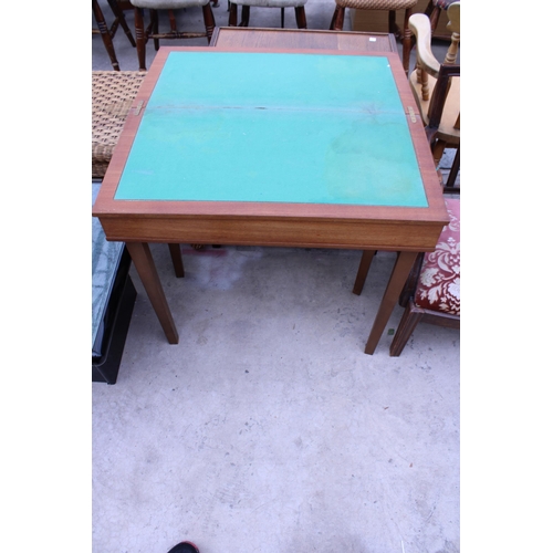 2545 - A RETRO TEAK FOLD OVER GAMES TABLE WITH GREEN BAIZE PLAYING AREA