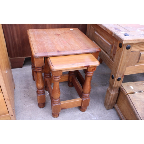 2663 - A MEXICAN PINE LAMP TABLE, WRITING SLOPE AND A NEST OF TWO TABLES