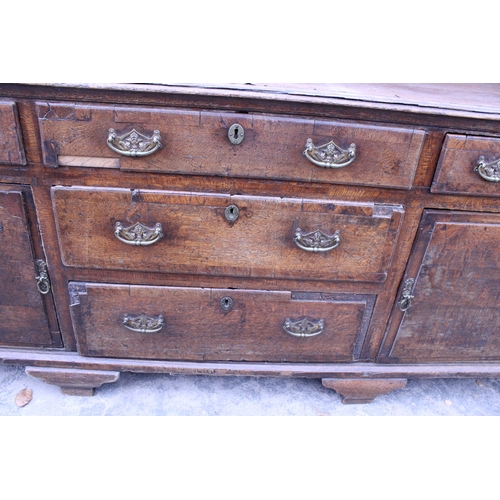 2767 - AN OAK AND CROSSBANDED GEORGE III DRESSER ENCLOSING FIVE DRAWERS AND TWO CUPBOARDS, 83