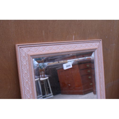 3000 - AN OVAL EDWARDIAN WALL MIRROR AND A BEVEL EDGE MIRROR