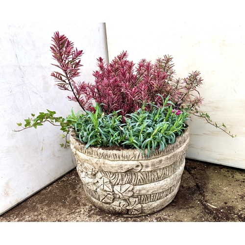 26 - ONE ORNAMENTAL CONCRETE PLANTER FILLED WITH MIXED PINK COLOURED HEBES, AND DIANTHUS. APPROX 40CM DIA... 