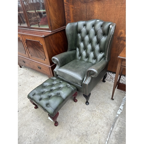 2525 - A GREEN LEATHER BUTTON-BACK WINGED FIRESIDE CHAIR ON CABRIOLE LEGS AND MATCHING STOOL