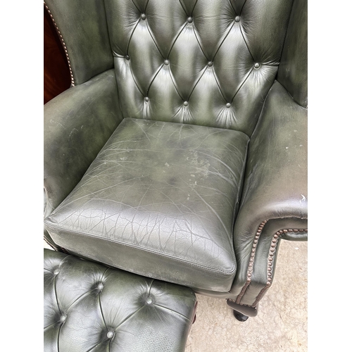 2525 - A GREEN LEATHER BUTTON-BACK WINGED FIRESIDE CHAIR ON CABRIOLE LEGS AND MATCHING STOOL