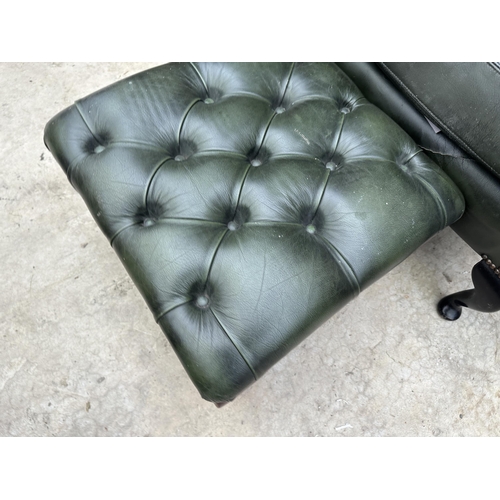 2525 - A GREEN LEATHER BUTTON-BACK WINGED FIRESIDE CHAIR ON CABRIOLE LEGS AND MATCHING STOOL