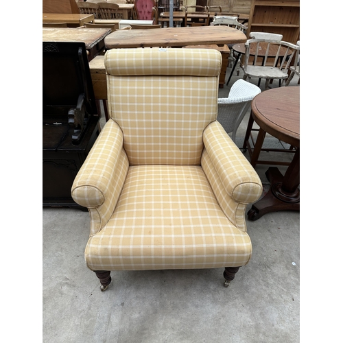 2553 - A LATE VICTORIAN SPRUNG AND UPHOLSTERED EASY CHAIR ON TURNED FRONT LEGS