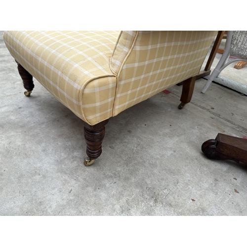 2553 - A LATE VICTORIAN SPRUNG AND UPHOLSTERED EASY CHAIR ON TURNED FRONT LEGS