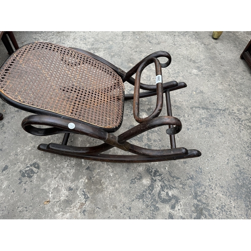 2569 - A THONET STYLE BENTWOOD AND CANE ROCKING FOOT REST