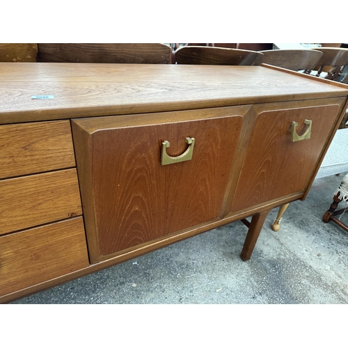 2656 - A RETRO TEAK NATHAN SIDEBOARD ENCLOSING THREE DRAWERS AND THREE CUPBOARDS WITH BRASS HANDLES, 72