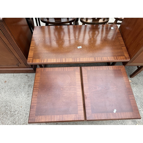 2657 - A MAHOGANY AND CROSSBANDED NEST OF THREE TABLES