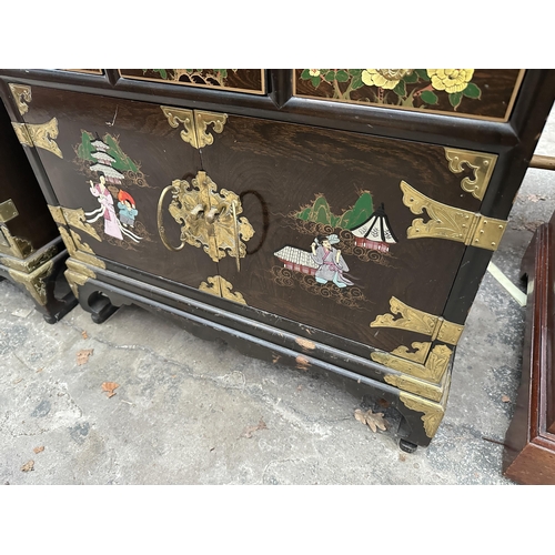 2660 - AN ORIENTAL EBONISED TWO DOOR GLAZED CABINET WITH THREE DRAWERS AND CUPBOARDS TO BASE, ALL WITH APPL... 