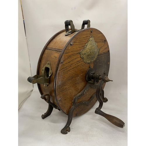 18 - AN ANTIQUE KNIFE SHARPENER BY FOLLOWS AND BATE LTD WITH AN OAK CASE, CAST IRON STAND AND CRANK