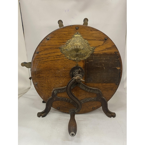 18 - AN ANTIQUE KNIFE SHARPENER BY FOLLOWS AND BATE LTD WITH AN OAK CASE, CAST IRON STAND AND CRANK