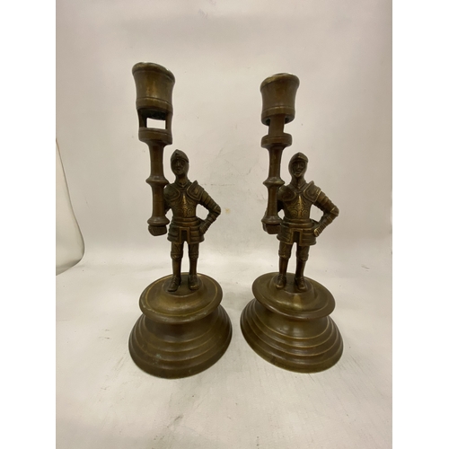 24 - A PAIR OF FRENCH BRASS MEDIEVAL PAW GUARD CANDLESTICK HOLDERS