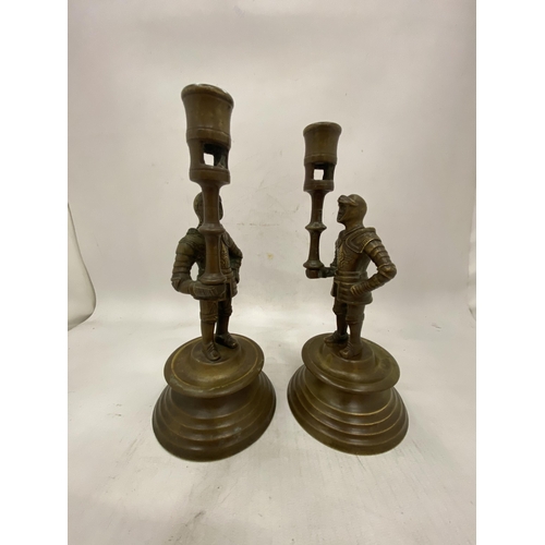 24 - A PAIR OF FRENCH BRASS MEDIEVAL PAW GUARD CANDLESTICK HOLDERS