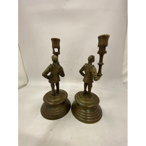 24 - A PAIR OF FRENCH BRASS MEDIEVAL PAW GUARD CANDLESTICK HOLDERS