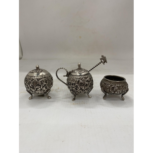 29 - A DECORATIVE FOUR PIECE INDIAN SILVER CRUET SET