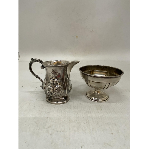 4 - TWO ITEMS OF HALLMARKED SILVER TO INCLUDE A SMALL BON BON DISH AND REPOUSSE FLORAL DESIGN JUG - GROS... 