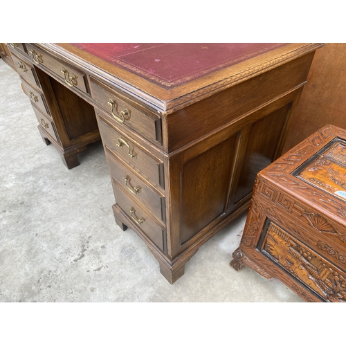 2513 - AN EDWARDIAN STYLE TWIN-PEDESTAL DESK ENCLOSING EIGHT DRAWERS WITH INSET LEATHER TOP, 54