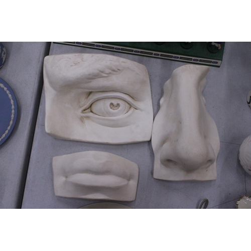 118 - THREE CARVED FACIAL FEATURES TO INCLUDE A NOSE, LIPS AND AN EYE