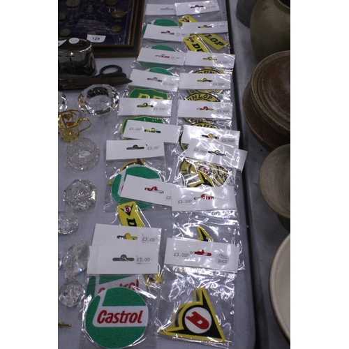 126 - TWENTY SEW ON MOTORING THEMED BADGES TO INCLUDE CASTROL, BP AND DUNLOP - ALL AS NEW IN PACKETS