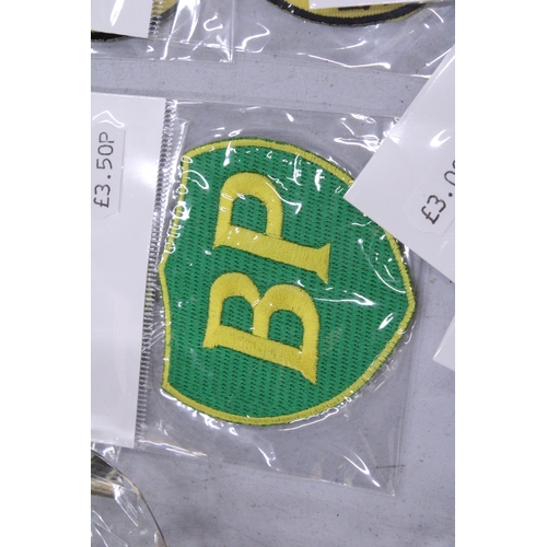 126 - TWENTY SEW ON MOTORING THEMED BADGES TO INCLUDE CASTROL, BP AND DUNLOP - ALL AS NEW IN PACKETS