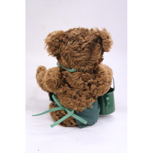 137 - A STEIFF 'GARDENER' TEDDY BEAR WITH APRON AND WATERING CAN AND BUTTON IN THE EAR