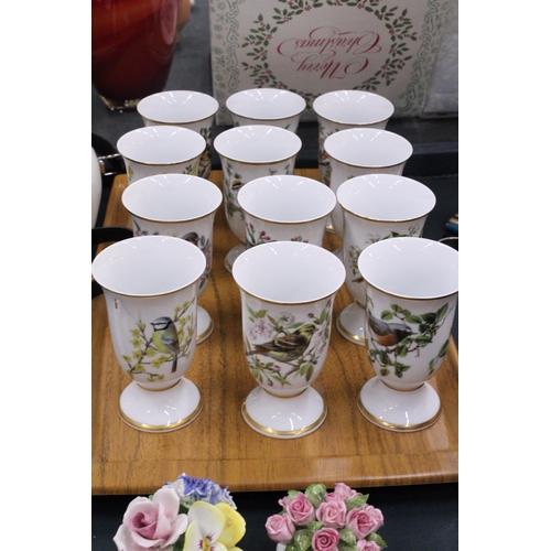 138 - A SET OF TWELVE BIRD THEMED CERAMIC BEAKERS ON A TEAK TRAY