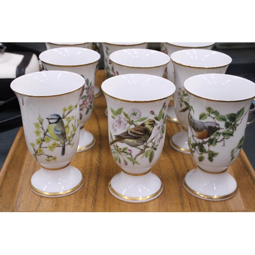 138 - A SET OF TWELVE BIRD THEMED CERAMIC BEAKERS ON A TEAK TRAY