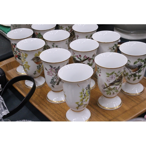 138 - A SET OF TWELVE BIRD THEMED CERAMIC BEAKERS ON A TEAK TRAY