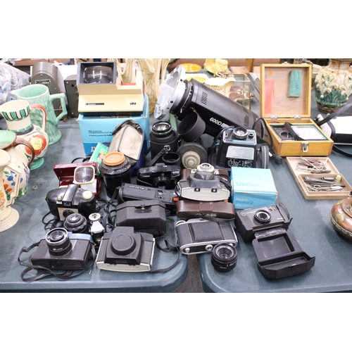 145 - A LARGE LOT OF VINTAGE CAMERAS AND LENSES