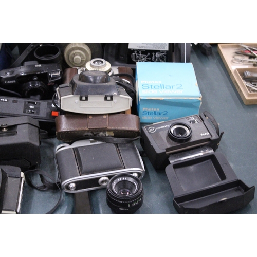 145 - A LARGE LOT OF VINTAGE CAMERAS AND LENSES