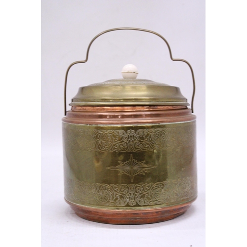 148 - A VINTAGE BRASS AND COPPER BISCUIT BARREL