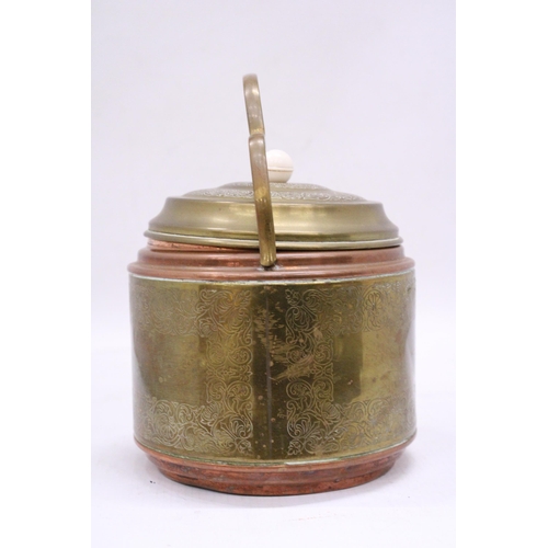 148 - A VINTAGE BRASS AND COPPER BISCUIT BARREL