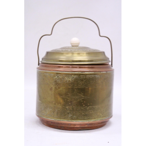 148 - A VINTAGE BRASS AND COPPER BISCUIT BARREL