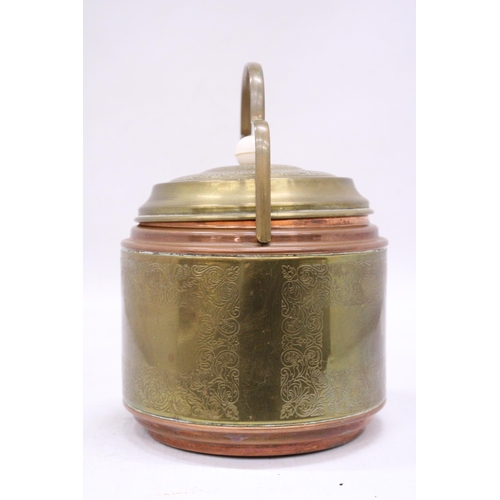 148 - A VINTAGE BRASS AND COPPER BISCUIT BARREL