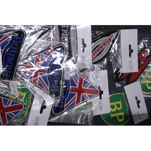 151 - TWENTY SEW ON MOTORING THEMED BADGES TO INCLUDE CASTROL, BP AND TRIUMPH - ALL AS NEW IN PACKETS