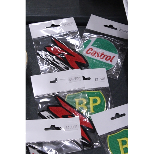 151 - TWENTY SEW ON MOTORING THEMED BADGES TO INCLUDE CASTROL, BP AND TRIUMPH - ALL AS NEW IN PACKETS