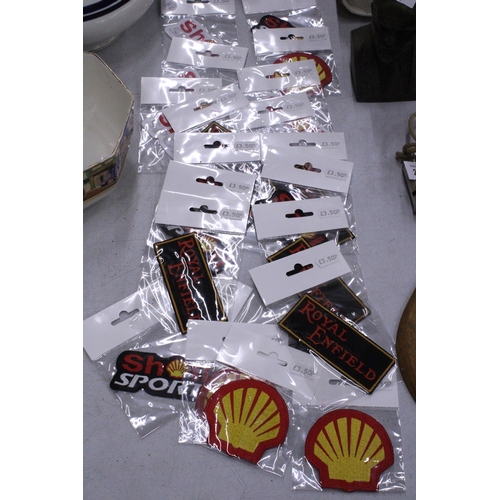 221 - TWENTY SEW ON MOTORING THEMED BADGES TO INCLUDE SHELL, AND ROYAL ENFIELD - ALL AS NEW IN PACKETS