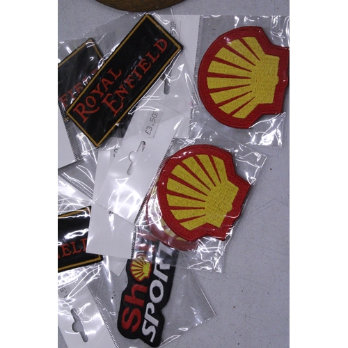 221 - TWENTY SEW ON MOTORING THEMED BADGES TO INCLUDE SHELL, AND ROYAL ENFIELD - ALL AS NEW IN PACKETS