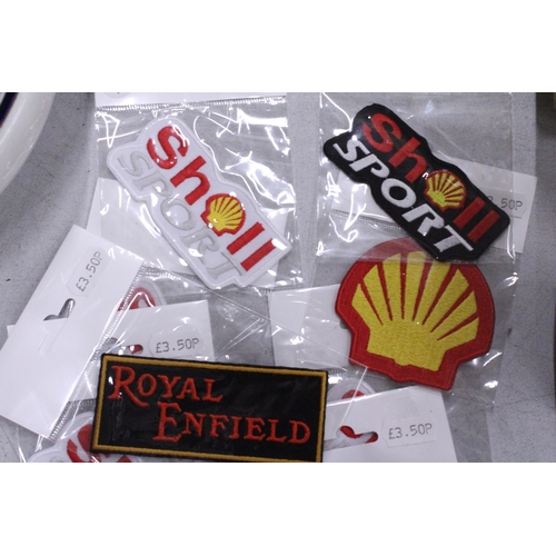 221 - TWENTY SEW ON MOTORING THEMED BADGES TO INCLUDE SHELL, AND ROYAL ENFIELD - ALL AS NEW IN PACKETS